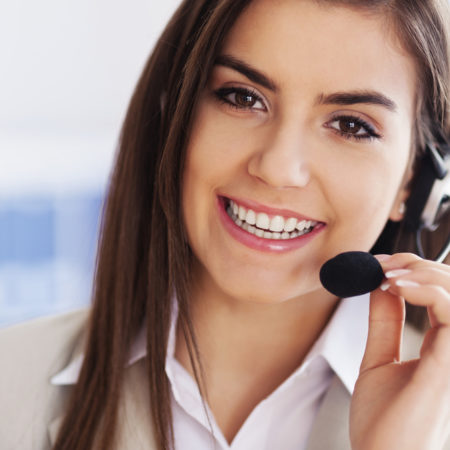 Happy female wearing headset and looking at camera