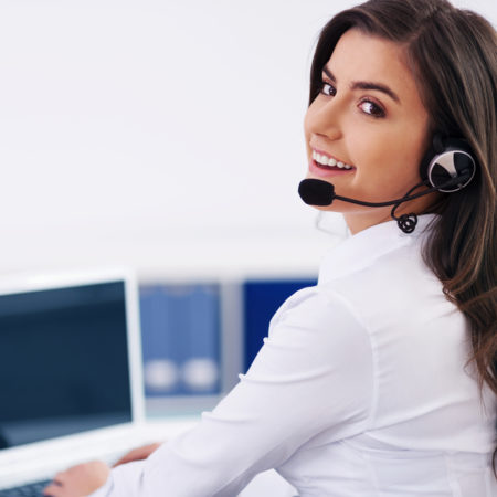 Young female operator with headphones